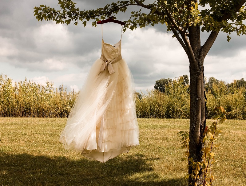 Wedding dress hanging from a tree