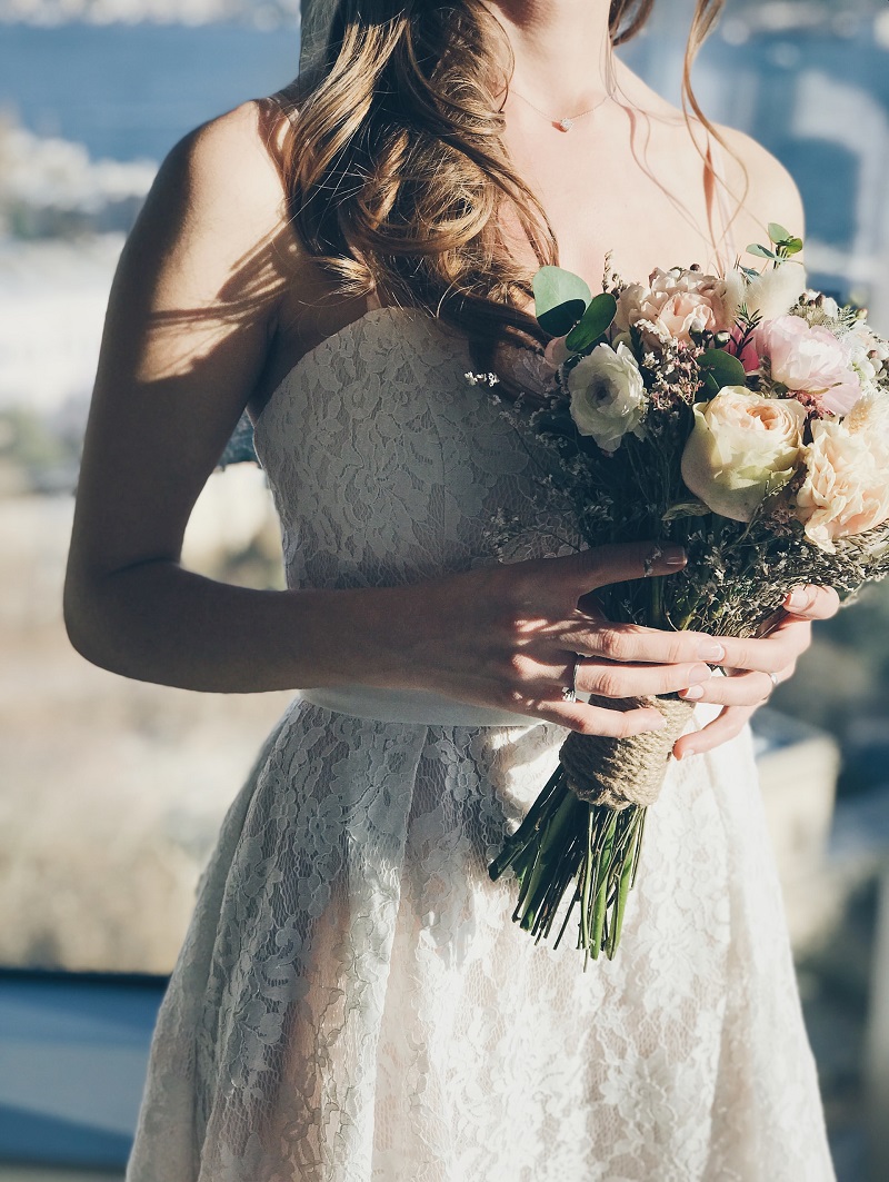 Bride with lace dress and rustic bouquet